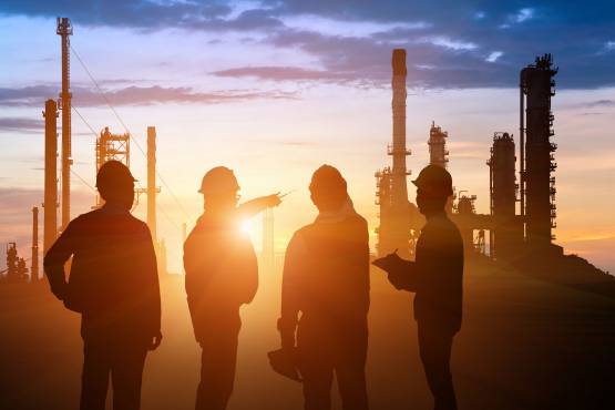Oil and Gas workers discussing work at dusk